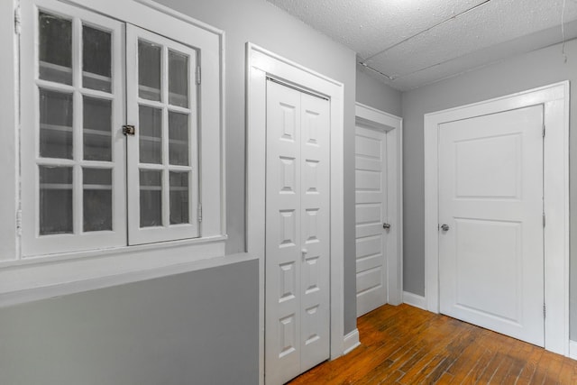 1812 John Ross Rd, Chattanooga, TN 37412 - doorway featuring dark wood-type flooring, a textured ceiling, and baseboards