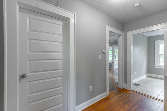 1812 John Ross Rd, Chattanooga, TN 37412 - hallway featuring hardwood / wood-style floors, plenty of natural light, baseboards, and a textured ceiling