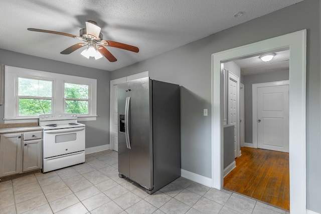 1812 John Ross Rd, Chattanooga, TN 37412 - kitchen featuring electric range, stainless steel fridge with ice dispenser, a ceiling fan, baseboards, and light countertops
