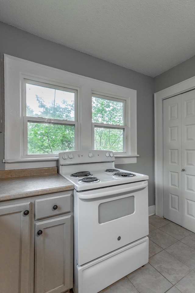 1812 John Ross Rd, Chattanooga, TN 37412 - kitchen with white electric stove, light tile patterned floors, light countertops, and a textured ceiling