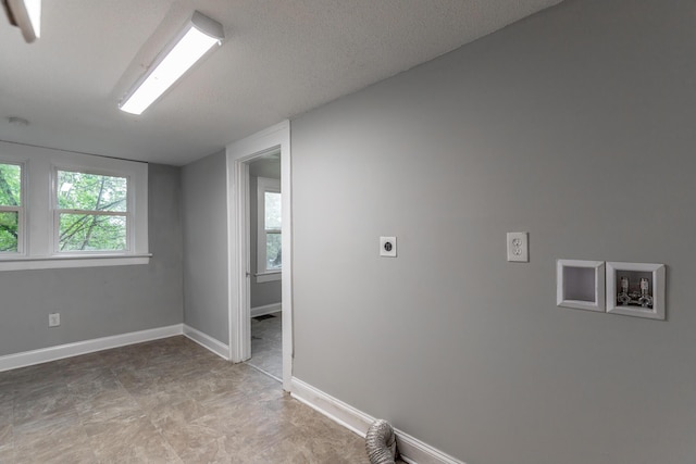 1812 John Ross Rd, Chattanooga, TN 37412 - clothes washing area with hookup for an electric dryer, hookup for a washing machine, healthy amount of natural light, and baseboards