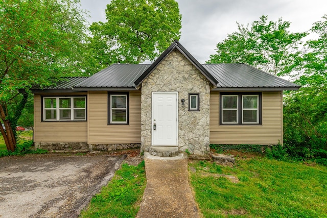 1812 John Ross Rd, Chattanooga, TN 37412 - view of front facade featuring metal roof, stone siding, and a front lawn