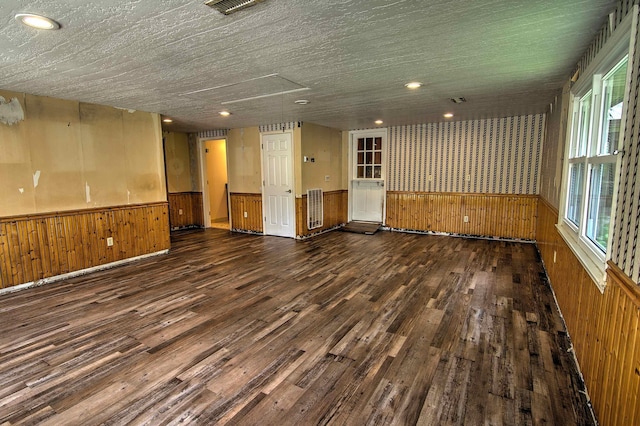 spare room with wooden walls, a wainscoted wall, recessed lighting, and wood finished floors