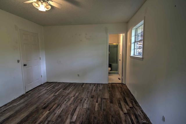 empty room featuring a textured ceiling, ceiling fan, and wood finished floors