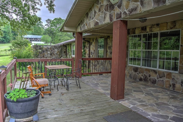 wooden terrace with outdoor dining area