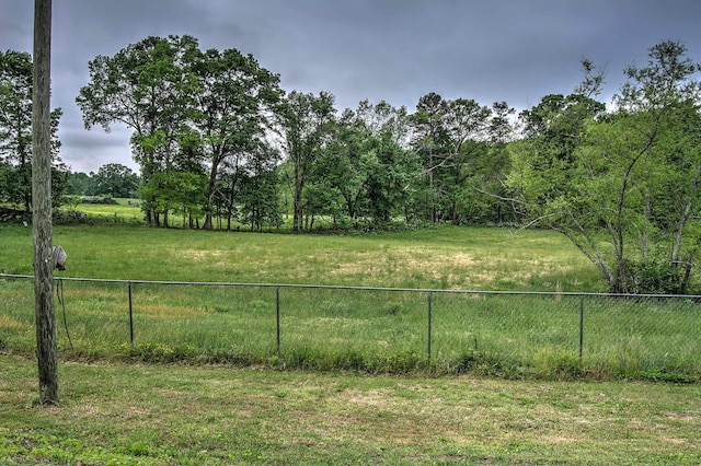 view of yard featuring a rural view and fence