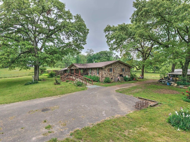 view of front of property with aphalt driveway and a front yard