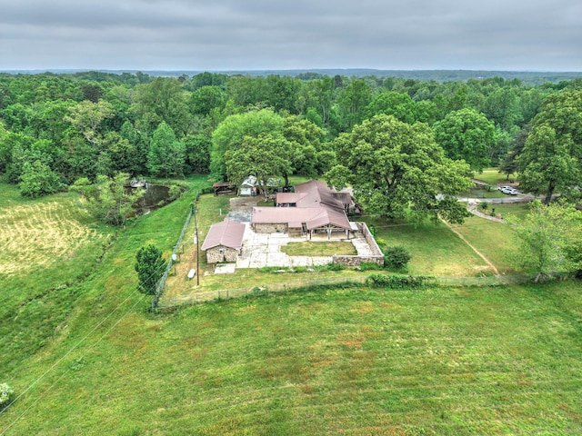 birds eye view of property with a view of trees