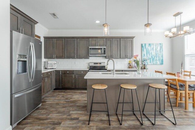 1826 Seven Pines Ln, Chattanooga, TN 37415 - kitchen featuring appliances with stainless steel finishes, crown molding, a sink, decorative backsplash, and dark brown cabinetry