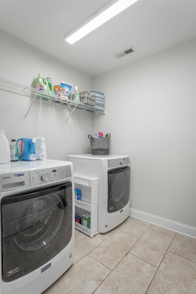 1826 Seven Pines Ln, Chattanooga, TN 37415 - laundry room featuring washer and clothes dryer, light tile patterned floors, and baseboards