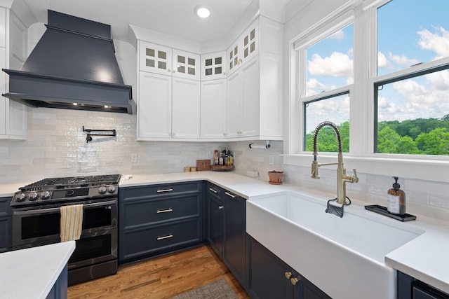 613 Ladd Ave, Chattanooga, TN 37405 - kitchen featuring light countertops, white cabinets, custom range hood, a sink, and double oven range