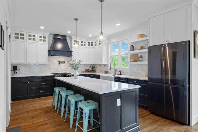 613 Ladd Ave, Chattanooga, TN 37405 - kitchen featuring custom range hood, freestanding refrigerator, a sink, and white cabinetry