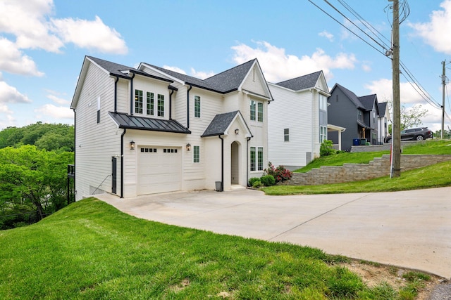 613 Ladd Ave, Chattanooga, TN 37405 - view of front of home with concrete driveway, an attached garage, a standing seam roof, and a front lawn