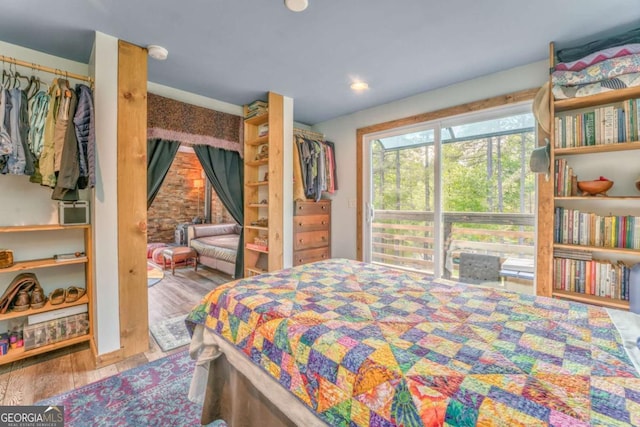 bedroom with recessed lighting and wood finished floors