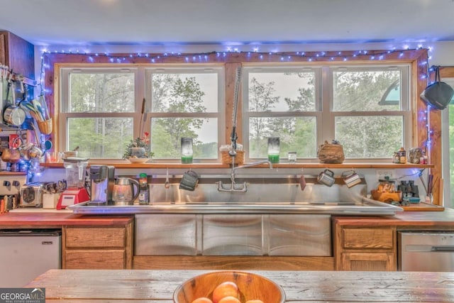 kitchen featuring stainless steel dishwasher and refrigerator