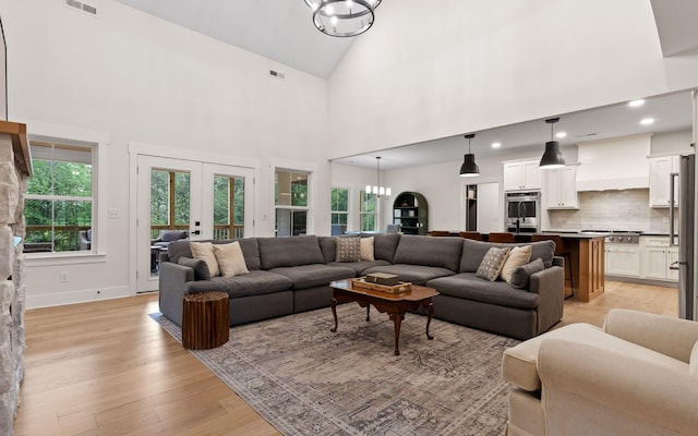 6949 Sawyer Rd, Signal Mountain, TN 37377 - living room with a chandelier, light wood-style flooring, high vaulted ceiling, recessed lighting, and french doors