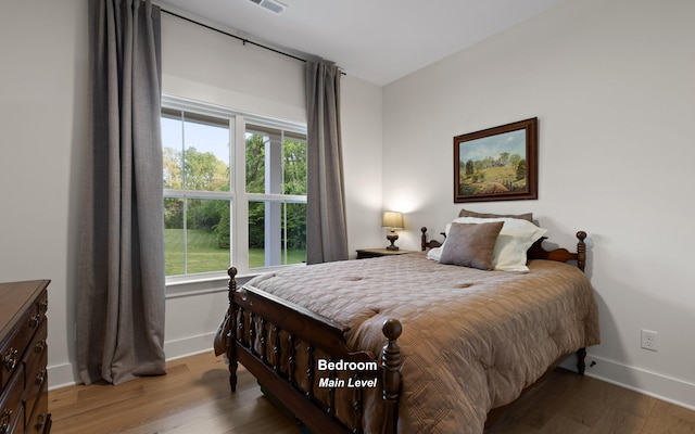 6949 Sawyer Rd, Signal Mountain, TN 37377 - bedroom featuring wood finished floors and multiple windows