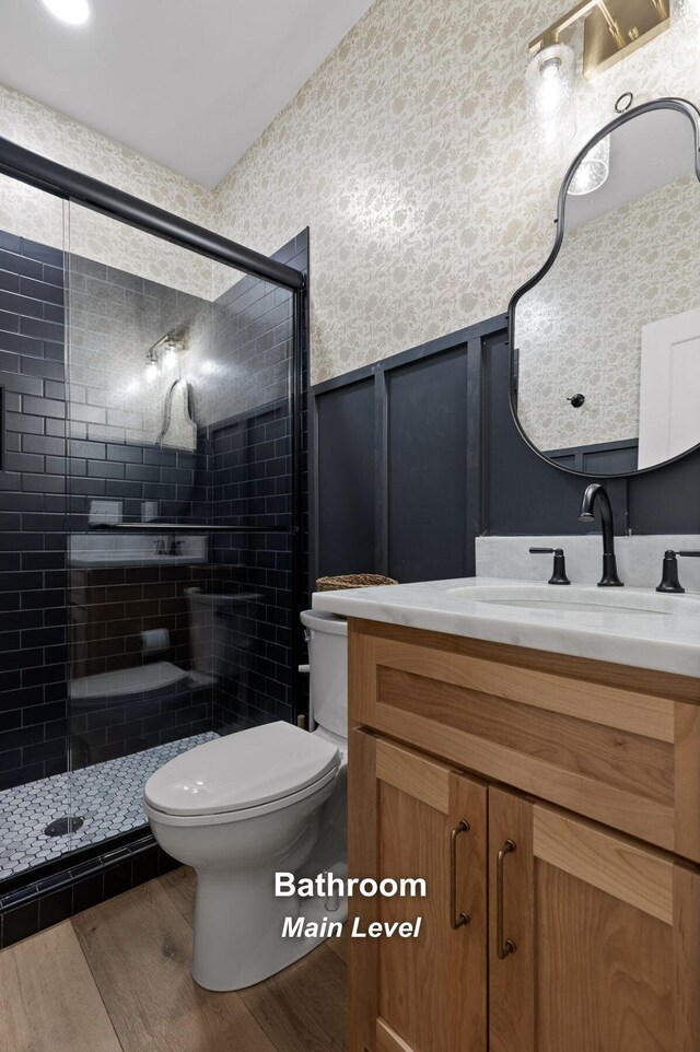 6949 Sawyer Rd, Signal Mountain, TN 37377 - full bathroom with wood finished floors, a wainscoted wall, vanity, a shower stall, and wallpapered walls