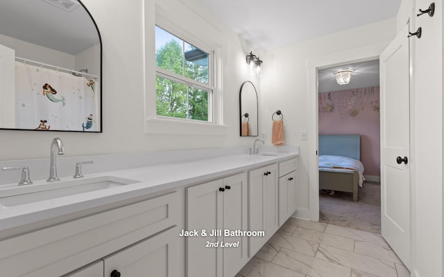 6949 Sawyer Rd, Signal Mountain, TN 37377 - full bathroom with double vanity, marble look tile flooring, and ensuite bathroom