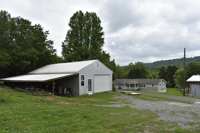view of outbuilding with an outdoor structure and driveway