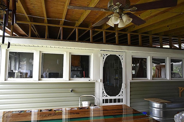 view of exterior entry featuring a ceiling fan
