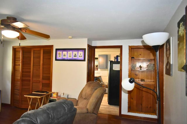 living room with a ceiling fan and wood finished floors
