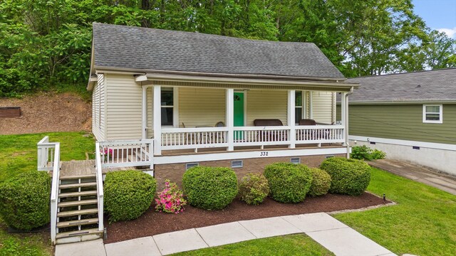 view of front of property with a porch, a shingled roof, stairs, and crawl space