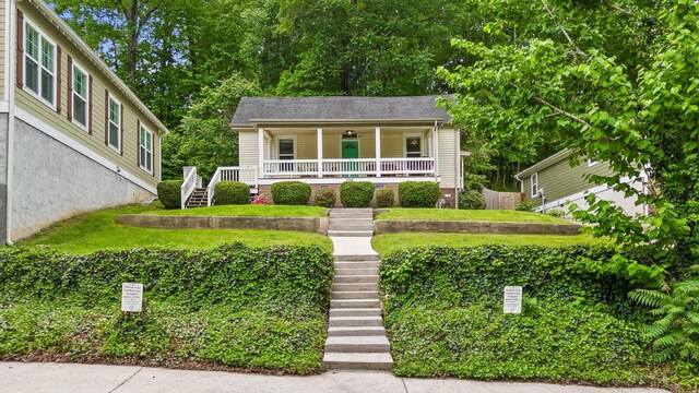 view of front of home with covered porch and stairs