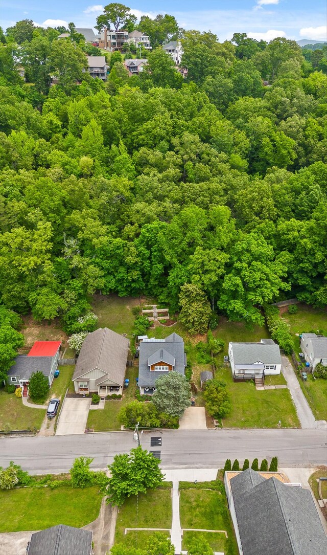 drone / aerial view with a residential view and a wooded view