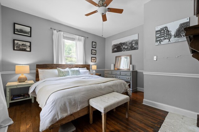 bedroom featuring baseboards, ceiling fan, and wood finished floors