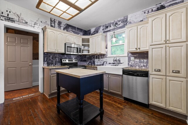 kitchen with appliances with stainless steel finishes, decorative light fixtures, backsplash, dark wood-style floors, and butcher block counters