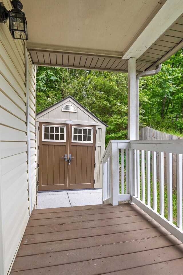 wooden terrace with an outbuilding and a shed