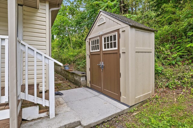 view of shed featuring stairway
