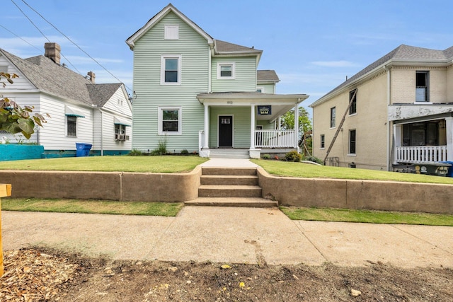 view of front of house with a porch and a front lawn
