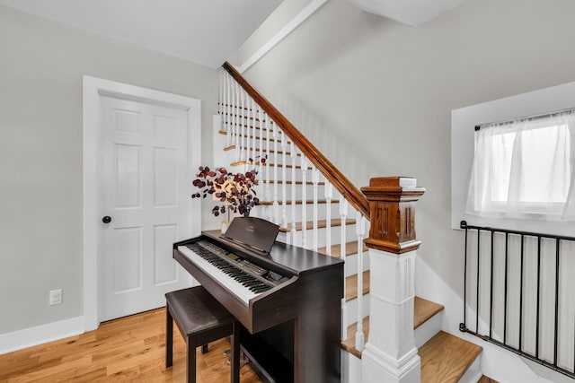 interior space featuring baseboards, stairs, and wood finished floors