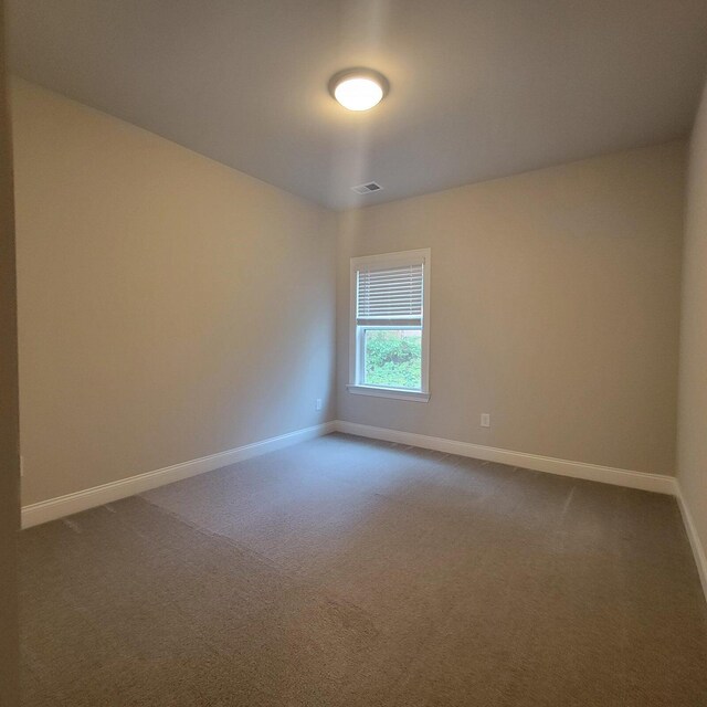 9573 Hastings Way, Ooltewah, TN 37363 - unfurnished room with baseboards, visible vents, and dark colored carpet
