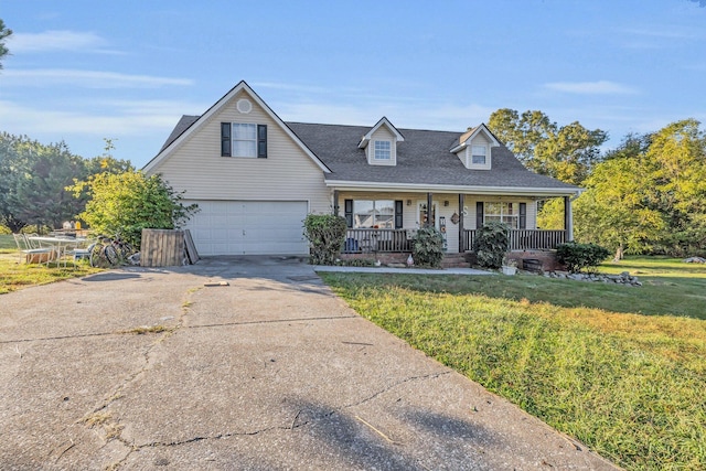 view of front of house with a shingled roof, an attached garage, a front yard, covered porch, and driveway