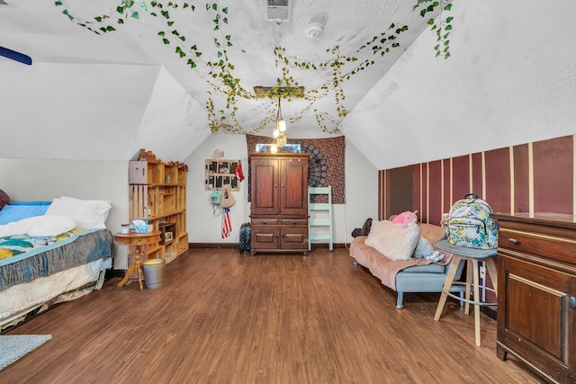 bedroom with baseboards, visible vents, dark wood-style floors, and vaulted ceiling