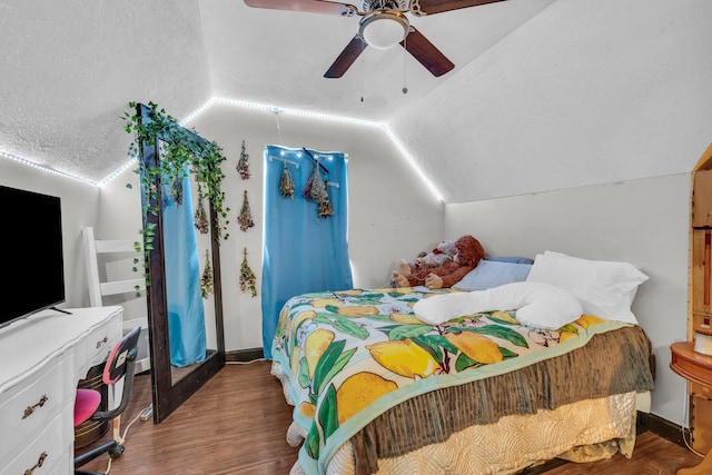 bedroom featuring wood finished floors, a textured ceiling, ceiling fan, and lofted ceiling