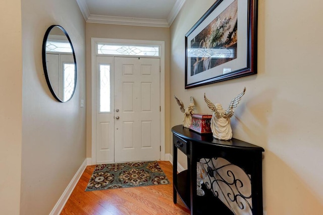 entryway with baseboards, ornamental molding, and wood finished floors