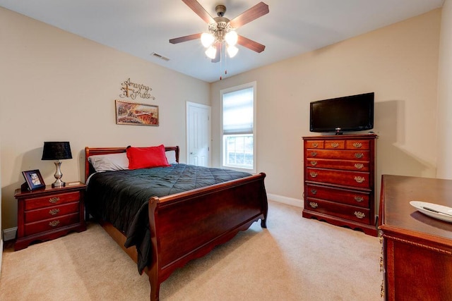 bedroom featuring baseboards, visible vents, ceiling fan, and carpet