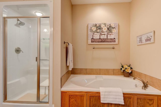 full bath featuring a shower stall and a garden tub