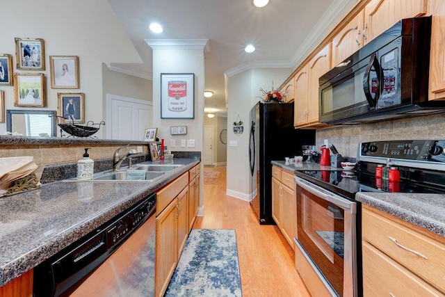 kitchen featuring ornamental molding, light wood-style floors, a sink, backsplash, and black appliances