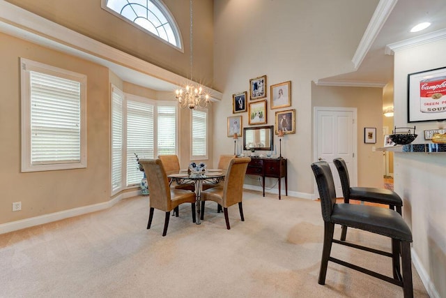 dining space with crown molding, baseboards, an inviting chandelier, and light carpet