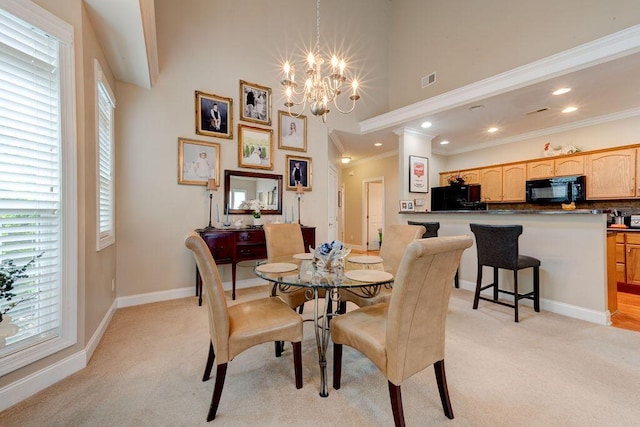 dining area featuring light carpet, a chandelier, and a wealth of natural light