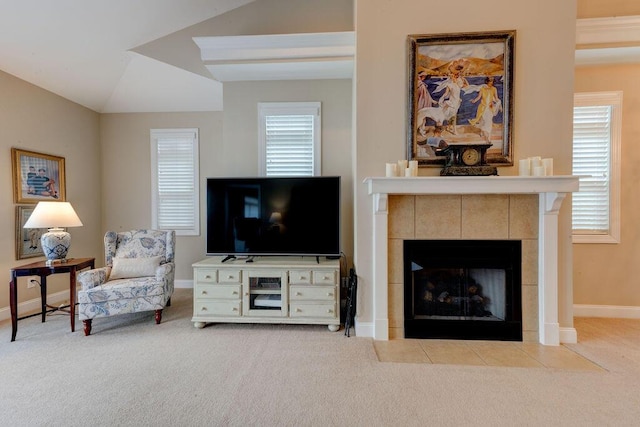 living room with carpet floors, baseboards, lofted ceiling, and a fireplace