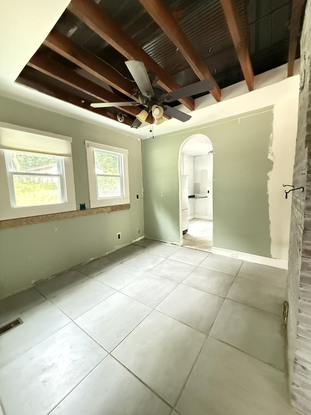 1021 W Elmwood Dr, Chattanooga, TN 37405 - unfurnished bedroom featuring arched walkways, tile patterned floors, visible vents, and beam ceiling