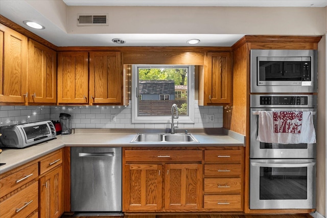 612 Carolina Ave, Signal Mountain, TN 37377 - kitchen with brown cabinetry, visible vents, a sink, a toaster, and stainless steel appliances
