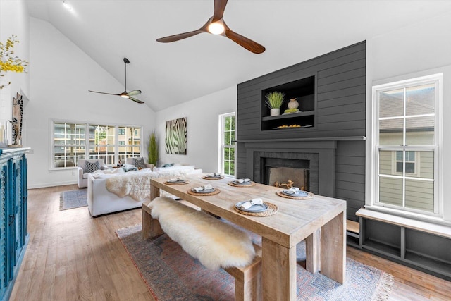 332 Oliver St, Chattanooga, TN 37405 - dining room with ceiling fan, a large fireplace, high vaulted ceiling, wood finished floors, and baseboards