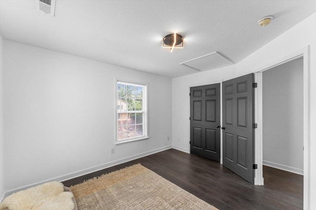 332 Oliver St, Chattanooga, TN 37405 - unfurnished bedroom with dark wood-style floors, baseboards, attic access, and a closet